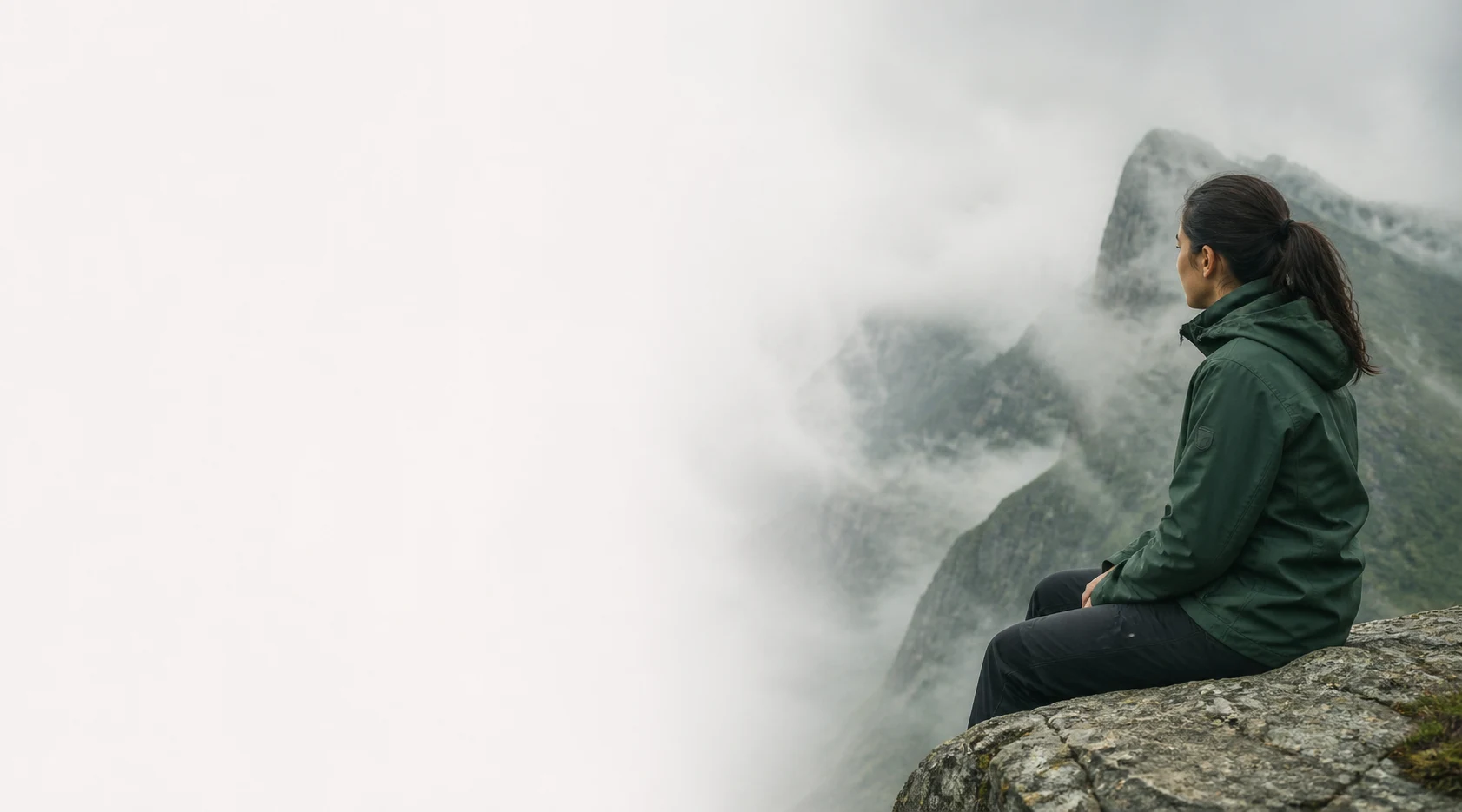 Woman wearing a durable outdoor jacket overlooking a mountain valley